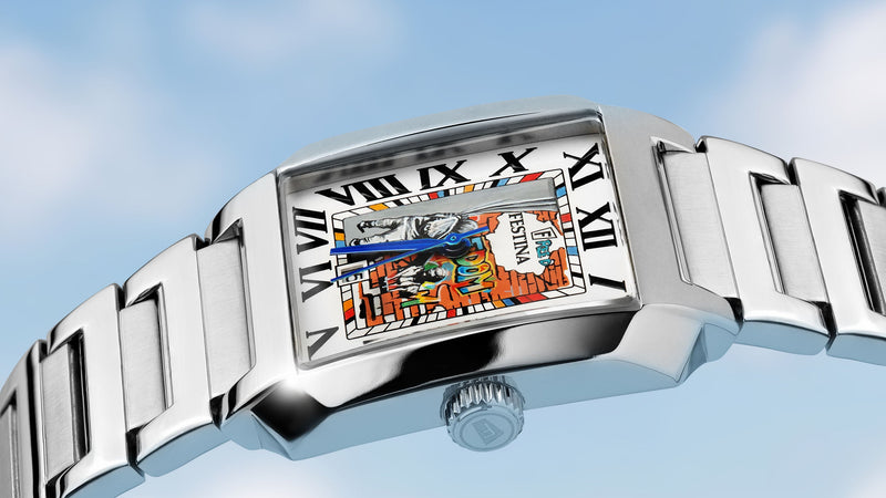Festina Freedom watch against a blue sky, square steel case with a hand-painted street-art dial and blued hands, by IFL Watches.
