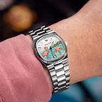 Bulova Super Seville Mini Havana — Custom hand-painted dial seen at the wrist, one flamingo bending to feed among ripples between silver baton markers, a bespoke timepiece by IFL Watches.