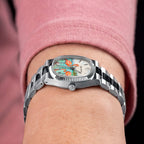 Bulova Super Seville Mini Havana — Side profile showing the fluted coin-edge bezel, crown and steel links, with the custom hand-painted flamingo dial in view, a bespoke timepiece by IFL Watches.