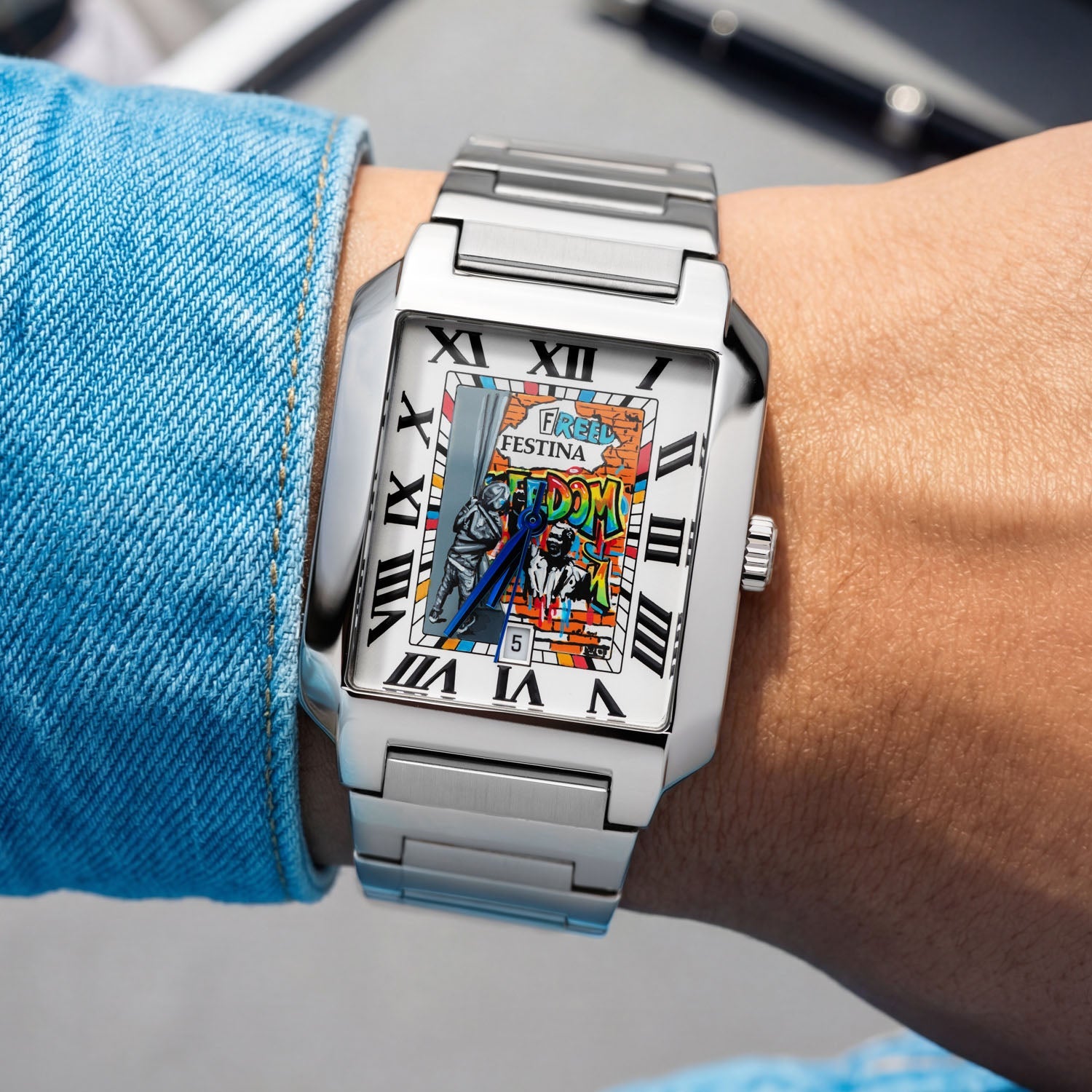 Festina Freedom 36 mm on wrist — custom hand-painted dial featuring graffiti-style text and stencil work in orange, yellow, blue, and green on the rectangular Festina On The Square. Limited edition by IFL Watches.