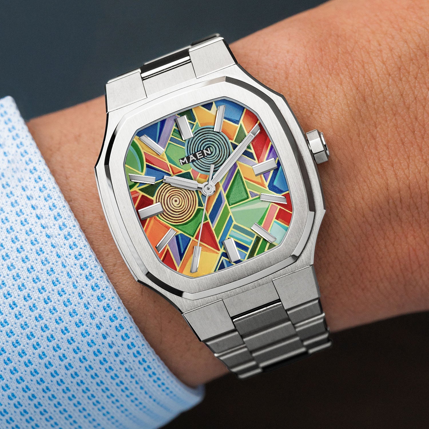 MAEN Manhattan Paradox — hand-painted geometric color-block dial with chevrons, mesh, and two concentric disks on a 37mm octagonal stainless steel case with integrated bracelet, limited edition timepiece by IFL Watches.