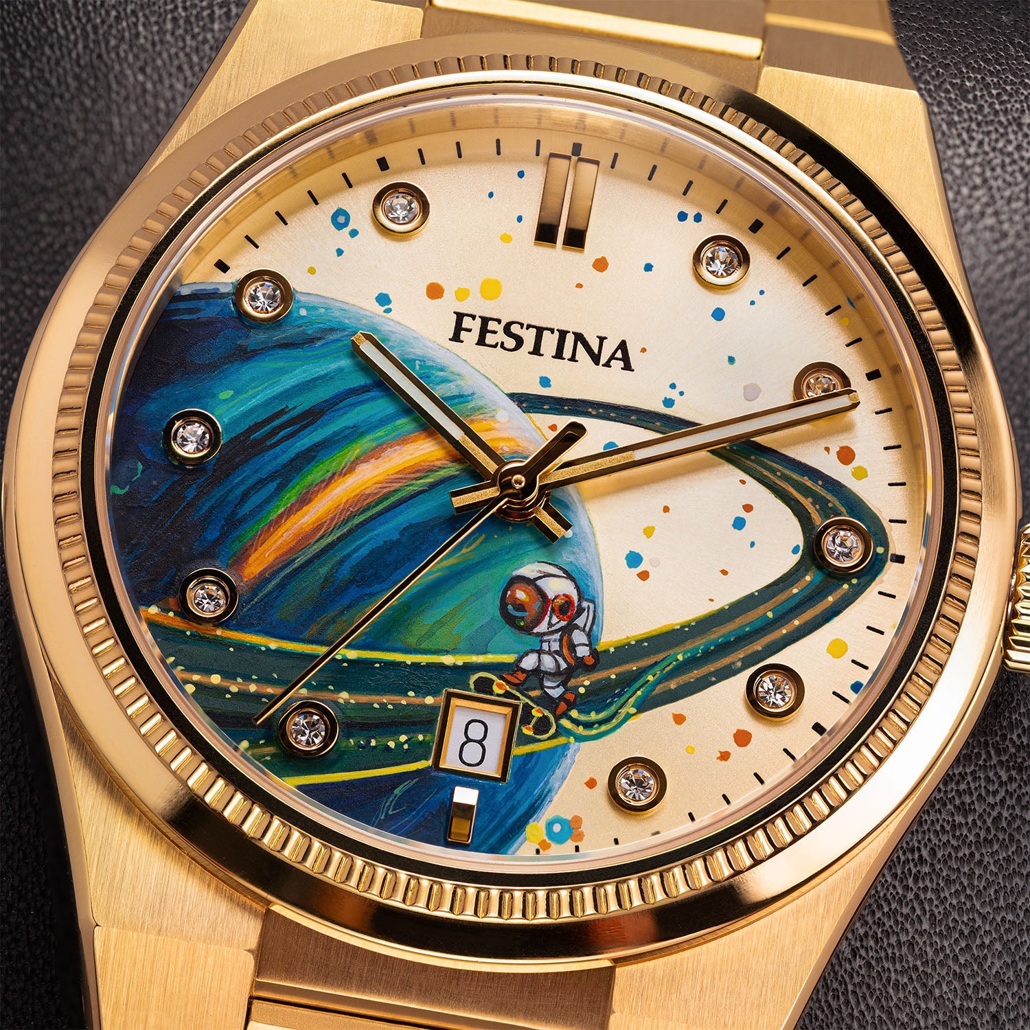 Festina Rive Space Ollie — Close detail of the hand-painted dial where an astronaut rides a board along the ring of a blue and green planet, beside crystal-set markers and a fluted gold bezel, bespoke by IFL Watches.