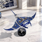 Mecha Ray Blue — displayed on a marble table beside design books and a flowering branch, kinetic sculpture by IFL Watches.