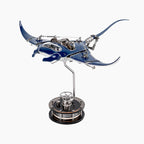 Mecha Ray Blue — the manta with wings raised mid-stroke, a chromed support arm rising from its weighted base, mechanical sculpture by IFL Watches.