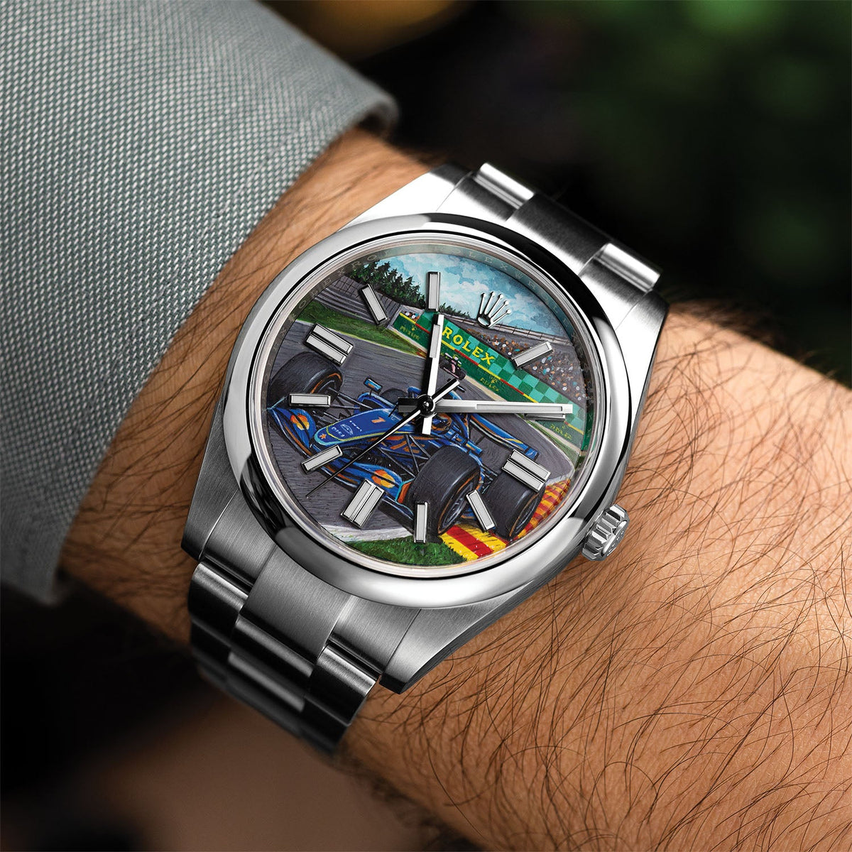 Apex Concept — Custom hand-painted dial worn on the wrist, showing the blue race car mid-corner against green verge and grandstand, a bespoke timepiece by IFL Watches.