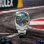 Apex Concept — Hand-painted racing dial photographed trackside on a painted kerb, blue race car at the inside edge of a corner, a bespoke timepiece by IFL Watches.