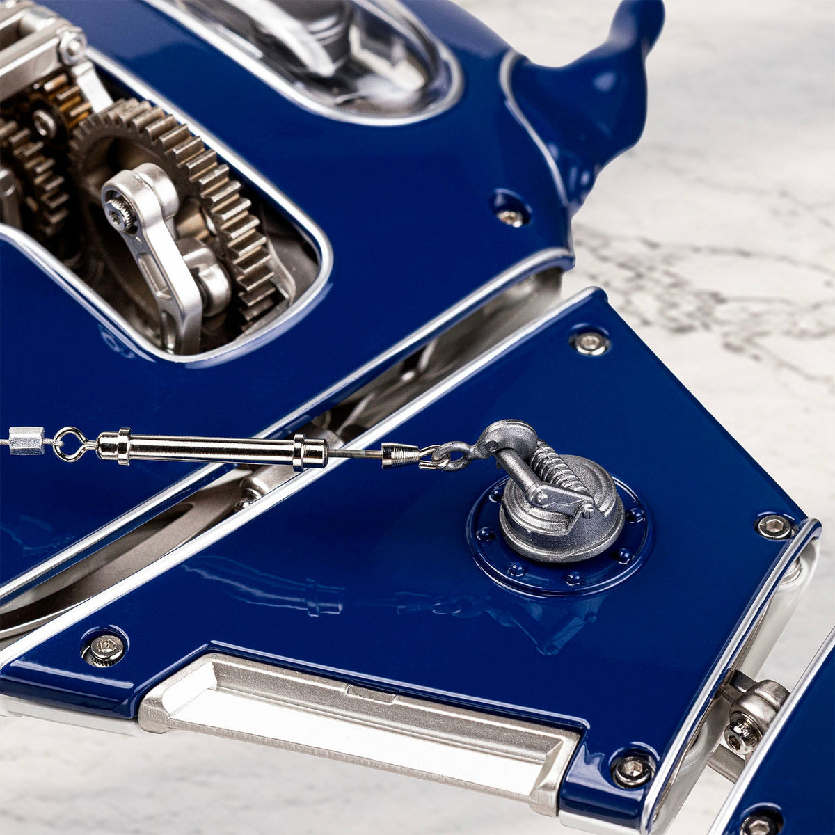 Mecha Ray Blue — detail of the gear cluster and turnbuckle that drive the wing, set into riveted bodywork, kinetic sculpture by IFL Watches.