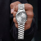 Citizen Tsuyosa Kanji held in hand — front-facing view showing the calligraphy-style indices at 12, 3, 6, and 9 with concentric finishing on the dial and stainless steel bracelet, a custom timepiece by IFL Watches.