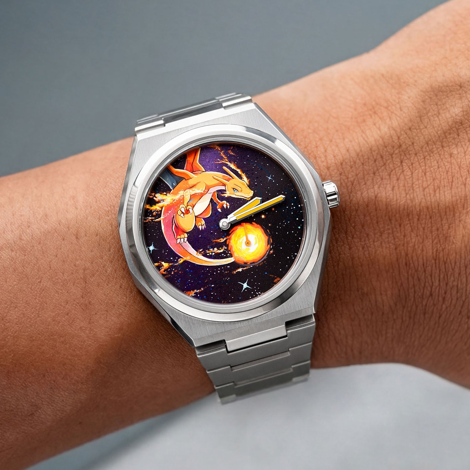 Defiant Inferno Concept on wrist — hand-painted fire-breathing icon visible against the cosmic black dial with hand-finished orange lume hands and a flame sub-dial, on a 40.5mm Super Titanium™ case with integrated bracelet, a bespoke timepiece by IFL Watches.