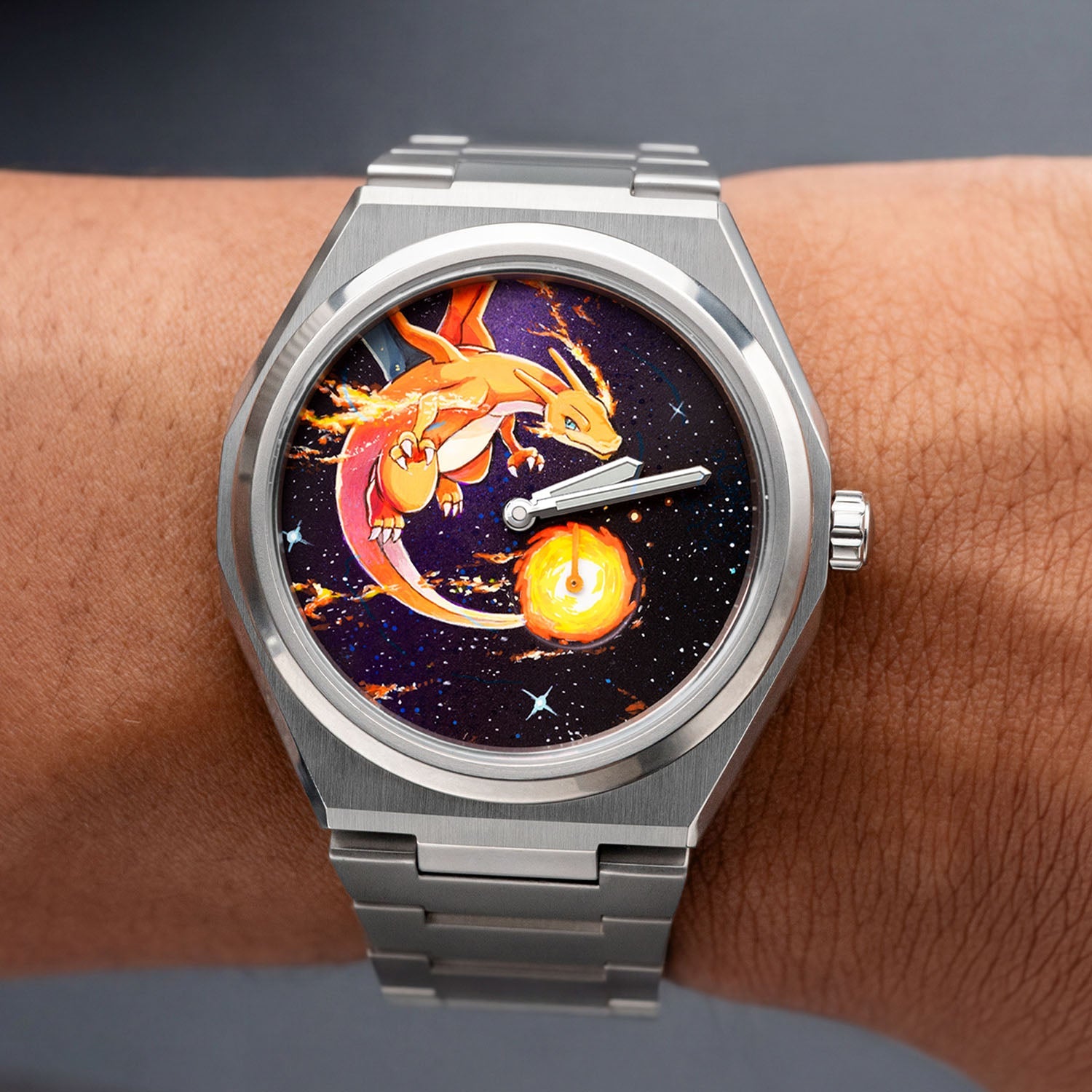 Defiant Inferno Concept on wrist — close-up of the hand-painted dial showing trailing flames and the cosmic night sky composition, 40.5mm Super Titanium™ automatic with hand-finished orange lume accents, a bespoke timepiece by IFL Watches.