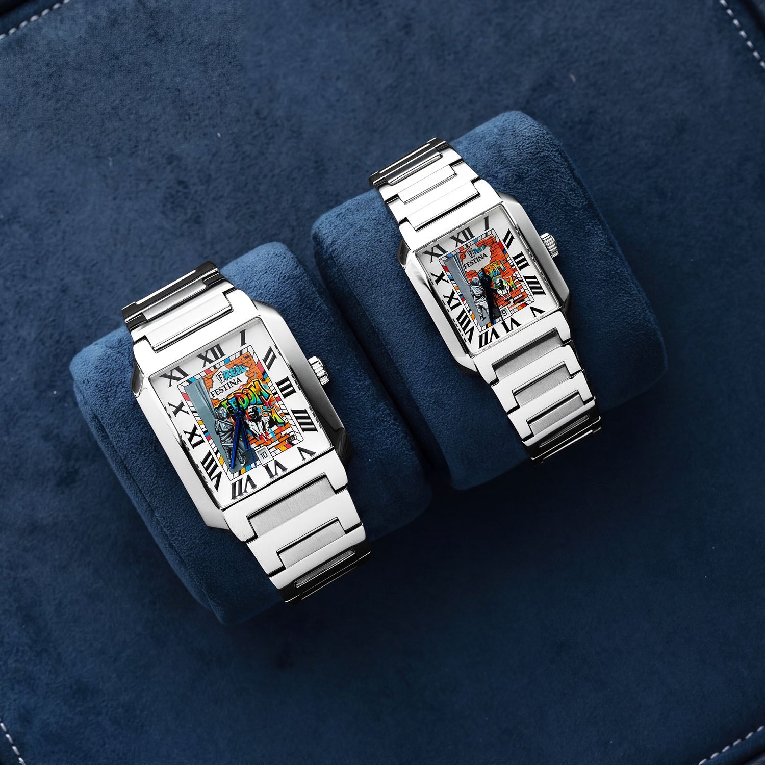 Festina Freedom — 36 mm and 29 mm side by side on navy suede cushions, featuring hand-painted street-art dials with Roman numerals and integrated steel bracelets. Limited edition by IFL Watches.