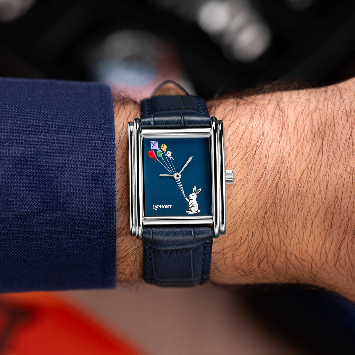 Laphont Bloc Skybound — Seen straight on at the wrist, the navy cuff pushed back from the stepped steel case as the kites climb across the dial, a custom limited edition watch by IFL Watches