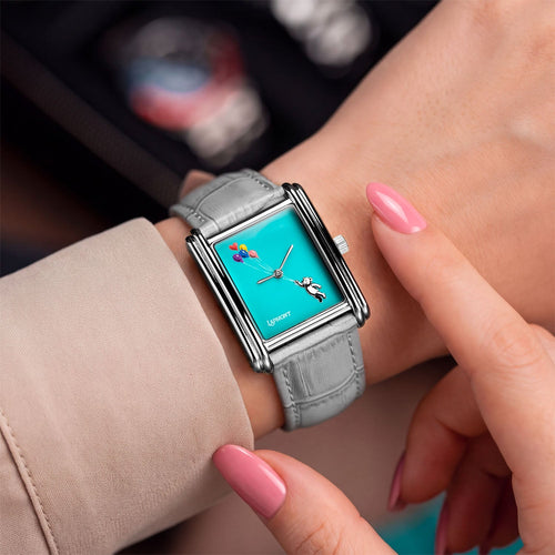 Laphont Bloc Cloudling — On a woman's wrist beneath a blush-beige sleeve, a pink-nailed fingertip resting by the crown beside the hand-painted bear and balloons, a custom limited edition timepiece by IFL Watches