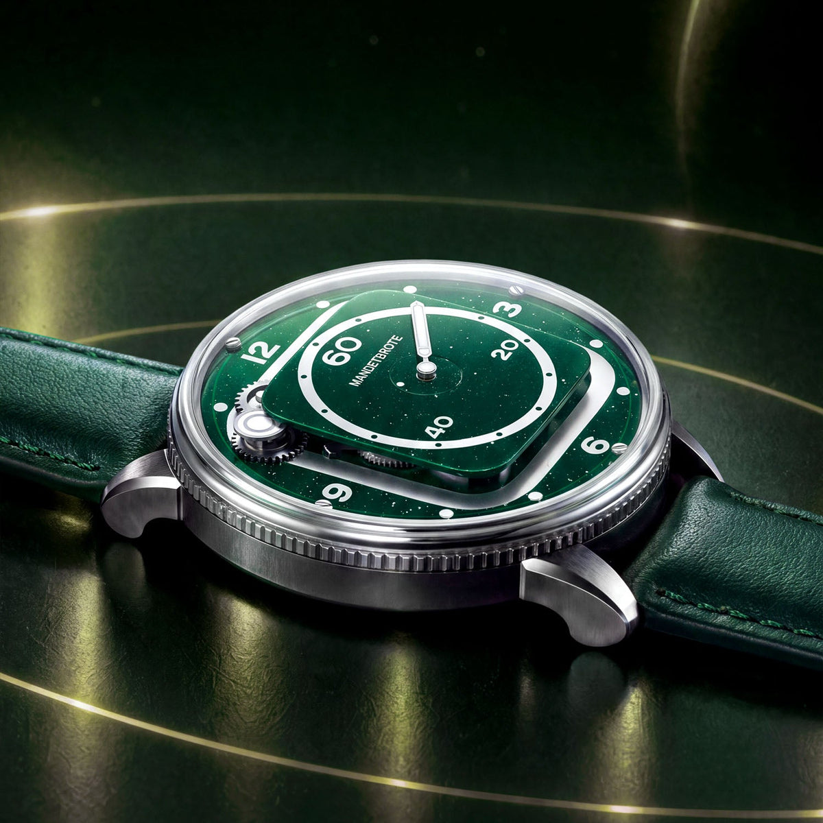 Mandetbrote Orbital II Green — Low side view on a gold-ringed surface, showing the case profile and coin-edge caseback, available at IFL Watches.