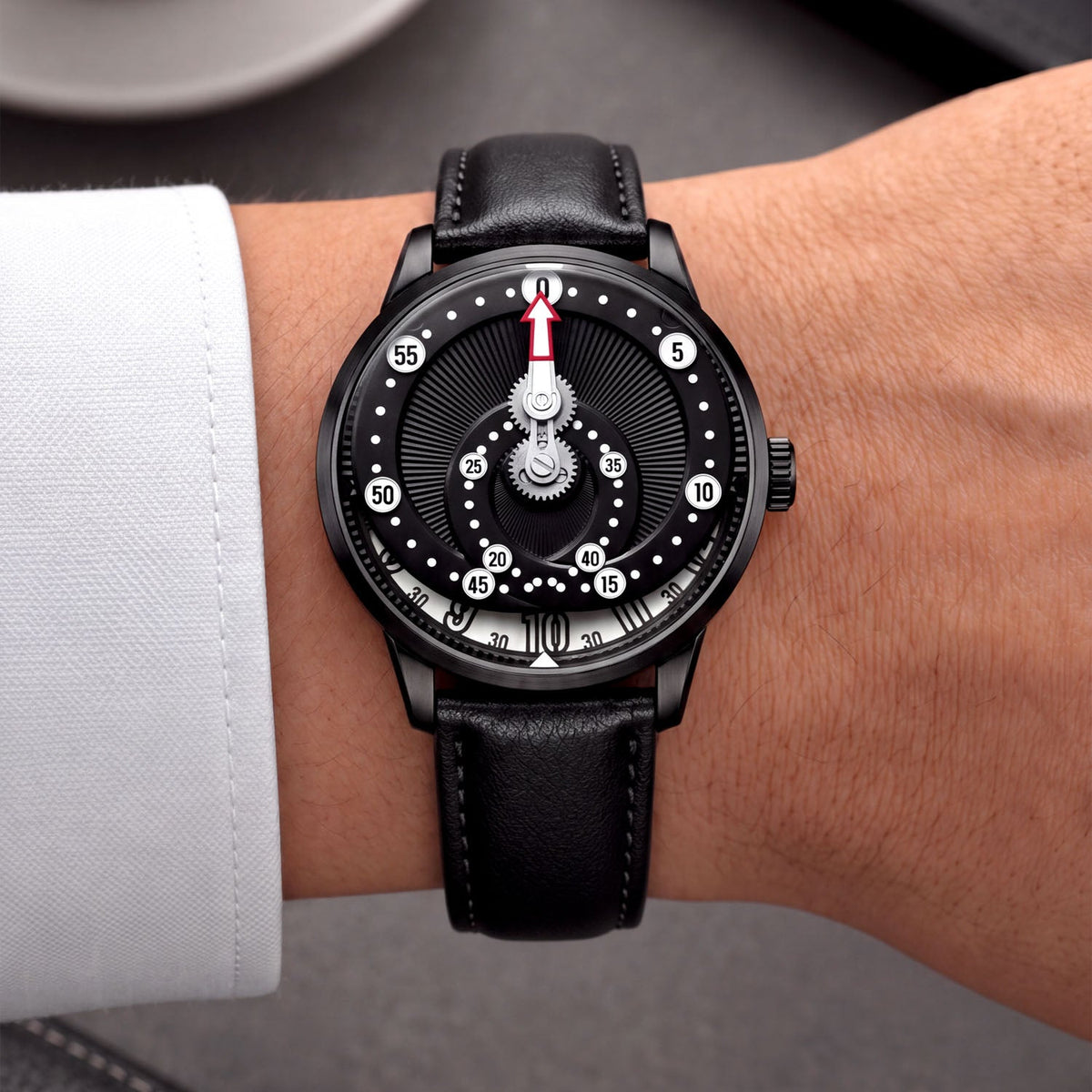 Mandetbrote Orbital Midnight Black — Worn on wrist with a white cuff, showing the minute arm and hour disc, available at IFL Watches.