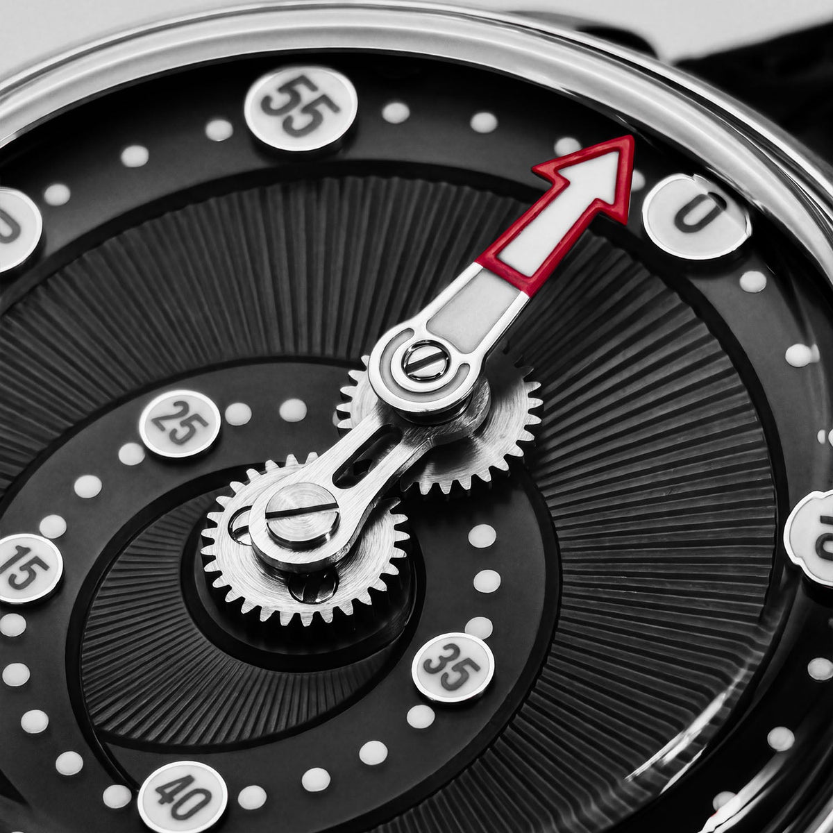 Mandetbrote Orbital Midnight Black — Macro detail of the geared minute arm and red-tipped hand over the radiating dial texture, available at IFL Watches.
