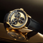 Mandetbrote Wandering Hour Gold — Angled on a reflective surface, showing the case and crown, available at IFL Watches.
