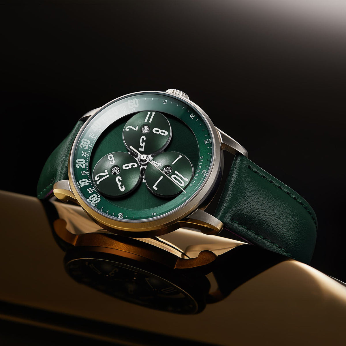 Mandetbrote Wandering Hour Green — Angled on a reflective surface, showing the case and crown, available at IFL Watches.