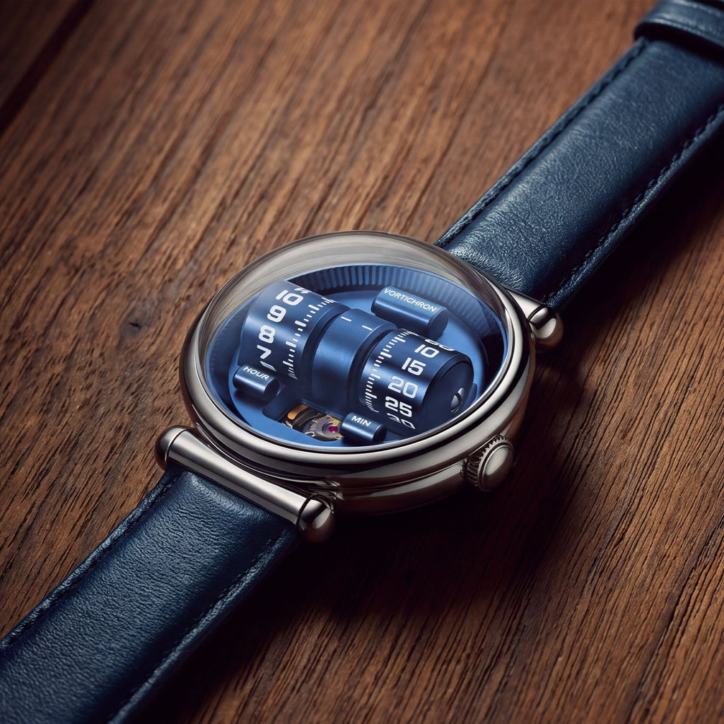 Vortichron Double Roller Blue — Lying on wood, seen from above with the rollers under the domed crystal, available at IFL Watches.