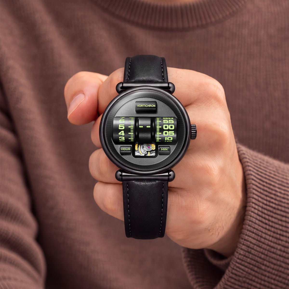 Vortichron Double Roller Midnight Black — Held in hand against a brown knit sweater, showing the two numbered rollers, available at IFL Watches.