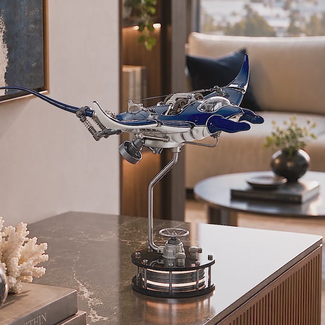 Mecha Ray Blue — the manta in motion on its stand on a marble side table, with close-ups of the gear train, sprung wing linkage and lacquered bodywork, kinetic metal sculpture by IFL Watches.